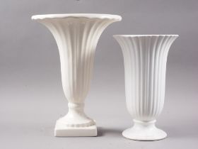 A Constance Spry design, Fulham Pottery, white glazed trumpet vase, 11" high, and a similar smaller