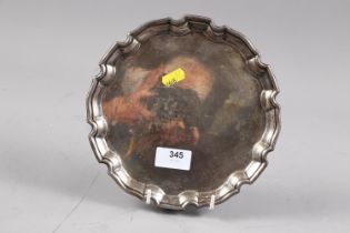 A silver piecrust edge salver, on three scrolled supports, 8" dia, 9.9 ozt approx