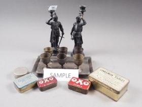 A pair of spelter candlesticks, formed as knights, 9 1/2" high, a rectangle brass shot tray and cups