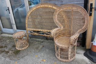 A rattan peacock chair with matching stool and headboard, chair 46" high, table 18" high and