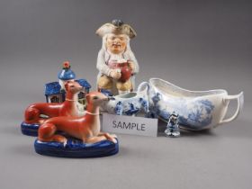 Two pairs of Staffordshire seated greyhound inkwells, a Staffordshire Toby jug (missing handle), a