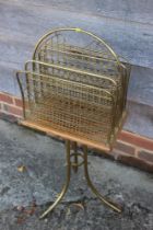 A late Victorian brass wirework magazine stand, on tripod splay supports, 35" high