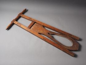 A wooden boot jack