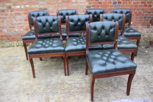 A set of eight reproduction mahogany dining chairs with back upholstered in a green leather, on