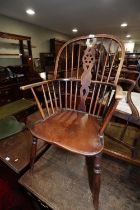A 19th century Windsor wheelback elbow chair with elm panel seat, on turned and stretchered supports