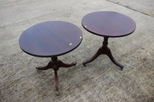 A pair of reproduction mahogany circular top occasional tables, on tripod splay supports, 24" dia