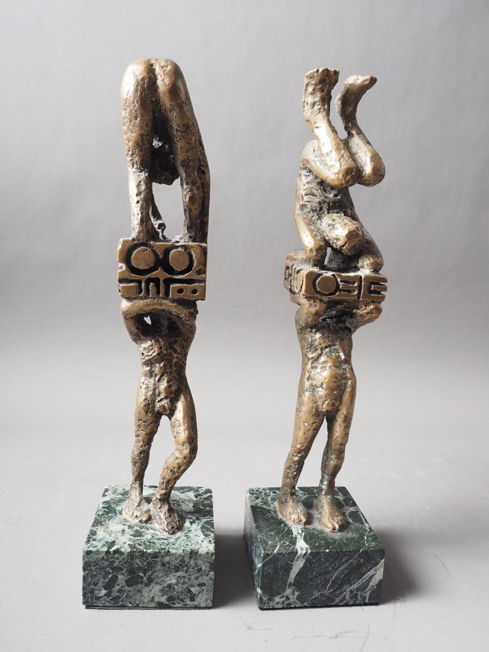 Ernest Bottomley: a pair of bronze "Techno Sculpture" figure groups, on green marble bases, 12 1/