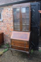 An early 20th century walnut and banded bureau bookcase, the upper section enclosed two doors over