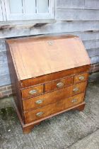 An early 18th century walnut and fruitwood line inlaid fall front bureau, the interior fitted