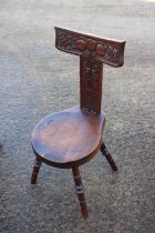 An Arts & Crafts carved hardwood spinning chair with "T" shaped back panel seat, on turned supports