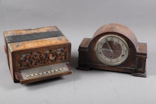 A maple and marquetry banded accordion, and an oak cased mantel clock with silvered dial and