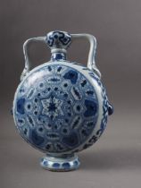 A Chinese porcelain blue and white moon flask with all-over geometric and scroll decoration, 8" high