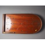 An early 20th century mahogany Holey Bogey Corinthian Bagatelle board with ball bearings and push