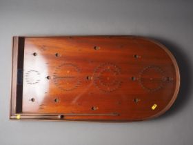 An early 20th century mahogany Holey Bogey Corinthian Bagatelle board with ball bearings and push