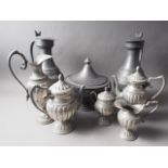 A pair of tappet hens, 14" high, a pewter five-piece tea and coffee set, and a pewter bowl and cover