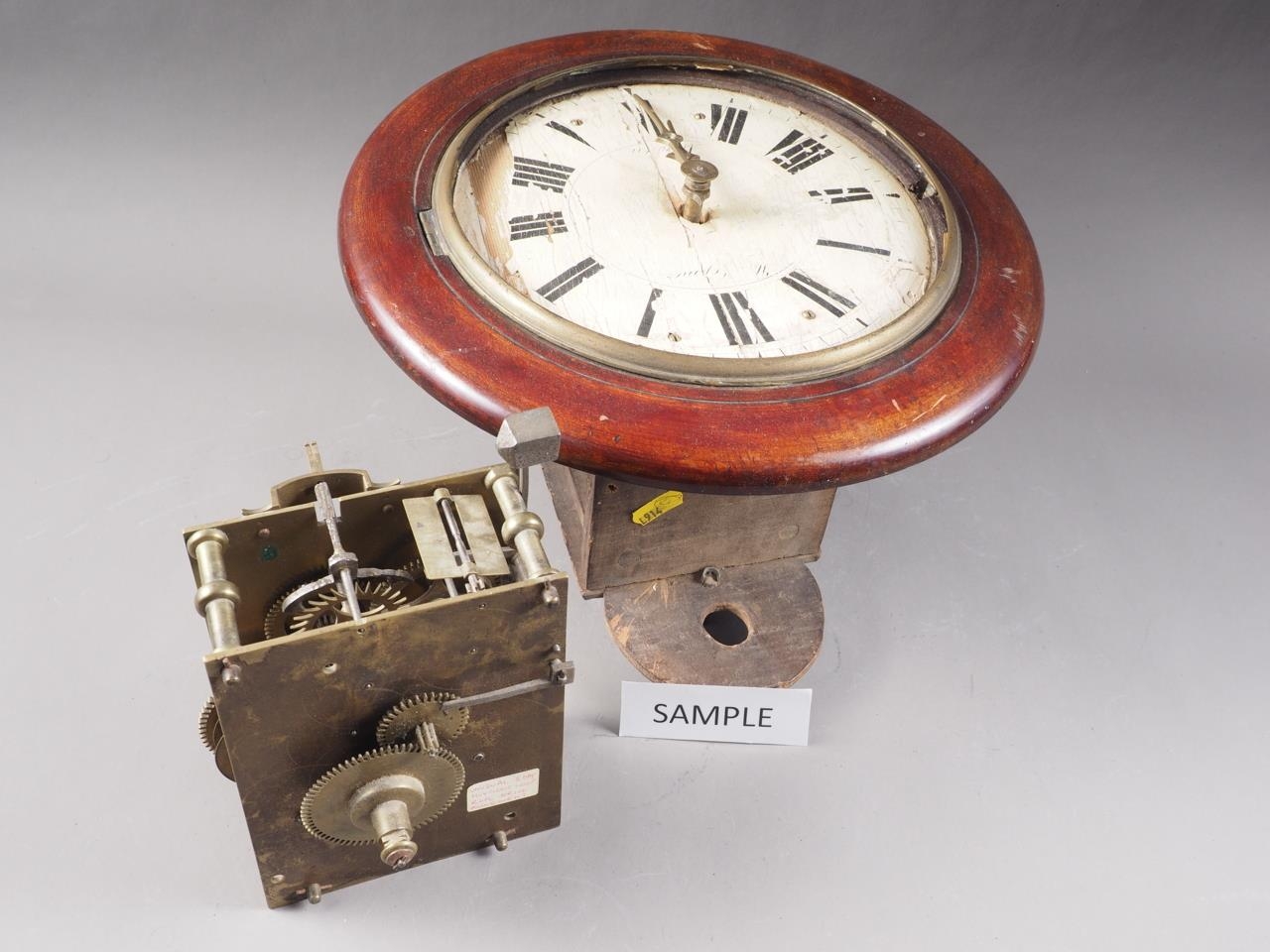 Two clock movements, a mahogany dial clock case with painted dial and Roman numerals, 12 1/2" dia,
