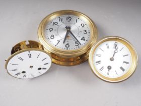 A French brass cylinder clock movement with white enamelled dial and Roman numerals, 4 3/8" dia, a