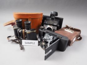 A Kershaw Eight-20 Penguin folding camera, in leather case, a Polaroid Square Shooter 2 Land Camera,