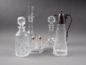 A Waterford cut glass decanter, a ship's decanter, three other decanters, a claret jug with plated