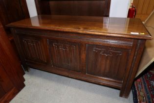 An oak coffer with triple linenfold panel front, on stile supports, 41 1/2" wide x 11 1/2" deep x