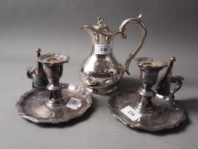 A pair of 19th century Sheffield plate chamber sticks and a plated hot water jug