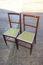 A pair of Edwardian mahogany and box line inlaid bedroom chairs with padded seats, on square taper