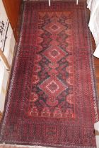 A Caucasian tribal rug with geometric design, animals and horses to centre ground and tree borders