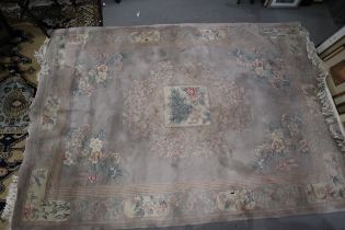 A Chinese contour pile carpet with all-over traditional floral design on a mushroom ground, 84” x