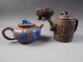 A Chinese Yixing pottery teapot with painted floral decoration and monkey finial, 3 3/4" high (