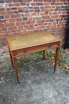 An Edwardian walnut writing table with tooled lined top, fitted one drawer, on square taper