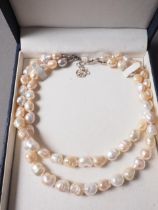 A double-stranded necklace of freshwater pearls with white metal clasp