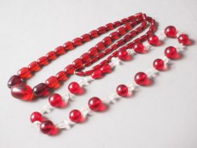 A cherry amber Bakelite bead necklace, the largest barrel shaped bead, 30mm long, 80.8g gross, and a