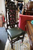 A carved oak side chair of early 17th century design with pierced scrollbar back and stuffed over