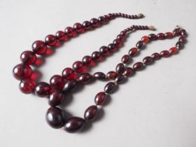 A cherry amber Bakelite round bead necklace, the largest bead, 20mm dia, 42.2g gross, and a