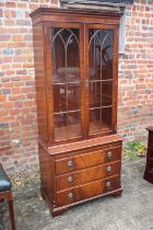 A burr walnut display cabinet, the upper section enclosed Gothic lattice doors over slide and