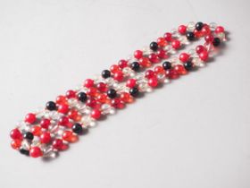 A cherry amber Bakelite and clear round bead necklace