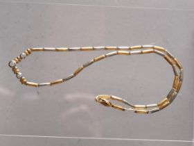 An 18ct two colour gold and diamond necklace, 21.2g