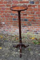 A reproduction mahogany torchere stand, on fluted column and tripod support, 12" dia x 41" high
