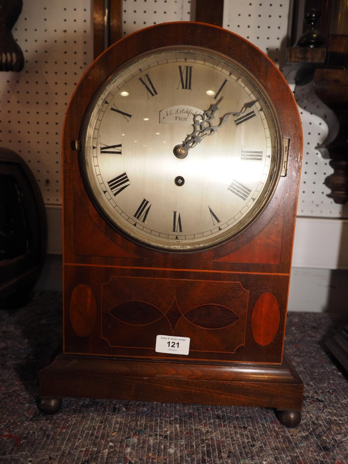 An Edwardian mahogany and line inlaid arch topped mantel clock with fusee movement, silvered dial