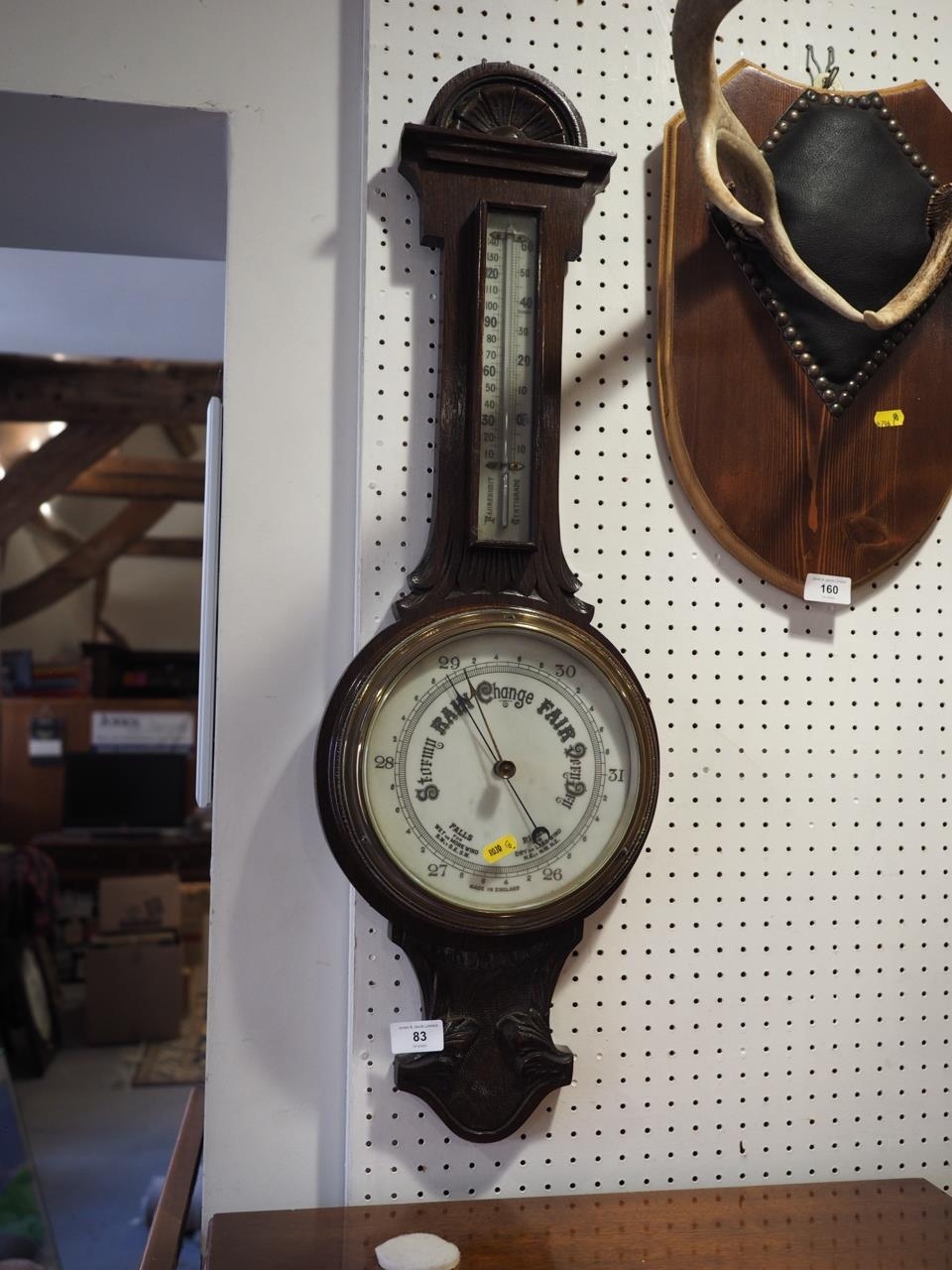 A 19th century carved oak cased aneroid barometer and thermometer, 31" high