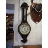 A 19th century carved oak cased aneroid barometer and thermometer, 31" high
