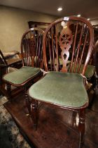 A Harlequin set of four 19th century Windsor wheelback chairs with elm panel seats, on turned and