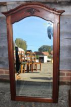 A  mahogany framed arch top wall mirror with bevelled plate, 38" x 18 1/2", and a 19th century