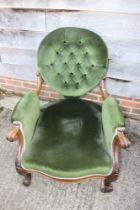 A Victorian button back deep seat open arm show frame chair, on cabriole supports