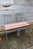 A two-seat chair back settee, upholstered in a gold, deep crimson and brown fabric, 37" wide