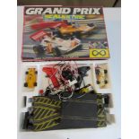 Scalextric Grand Prix track and two racing cars with controllers.