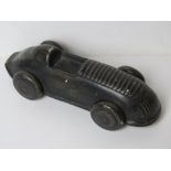 A ceramic paperweight in the form of a vintage racing car, approx 15.5cm in length.