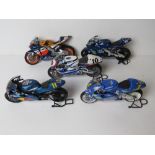 A quantity of five scale model racing bikes inc Suzuki, Honda and Yamaha.