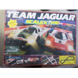 A Scalextric Team Jaguar race track in used condition having one car within.