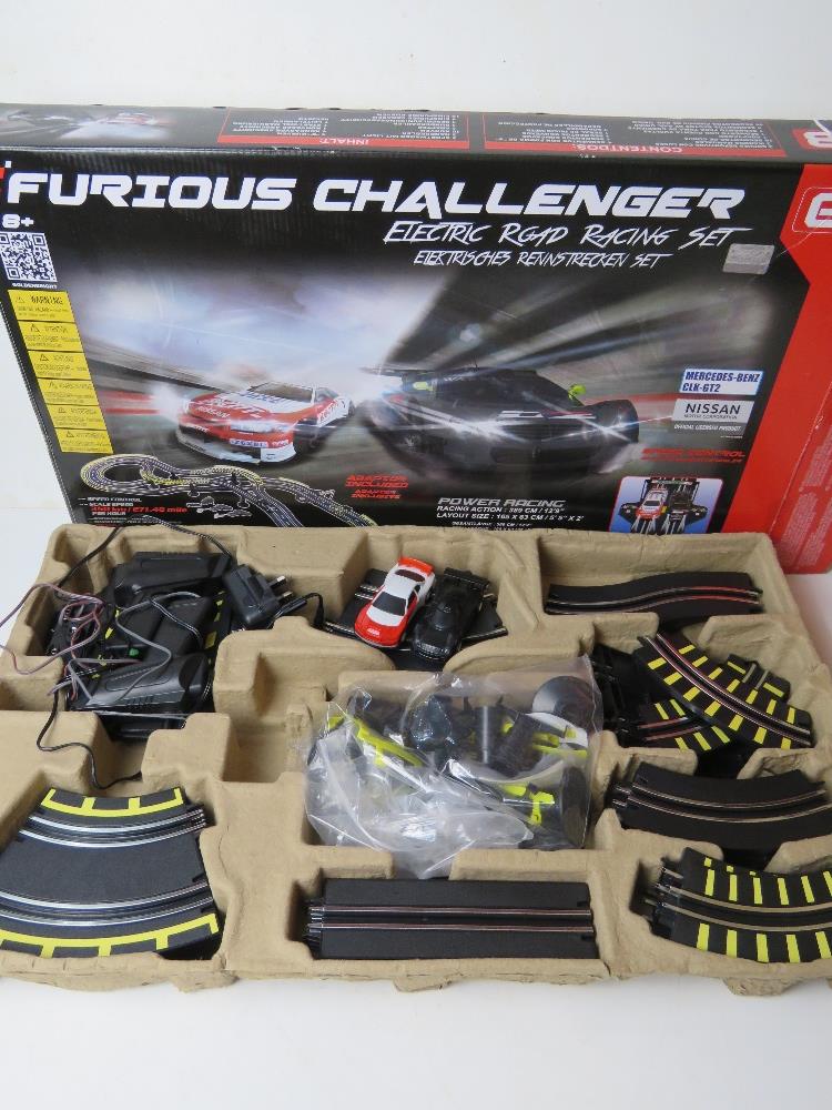 A Furious Challenger electric road racing set inc two cars, controllers and various track,